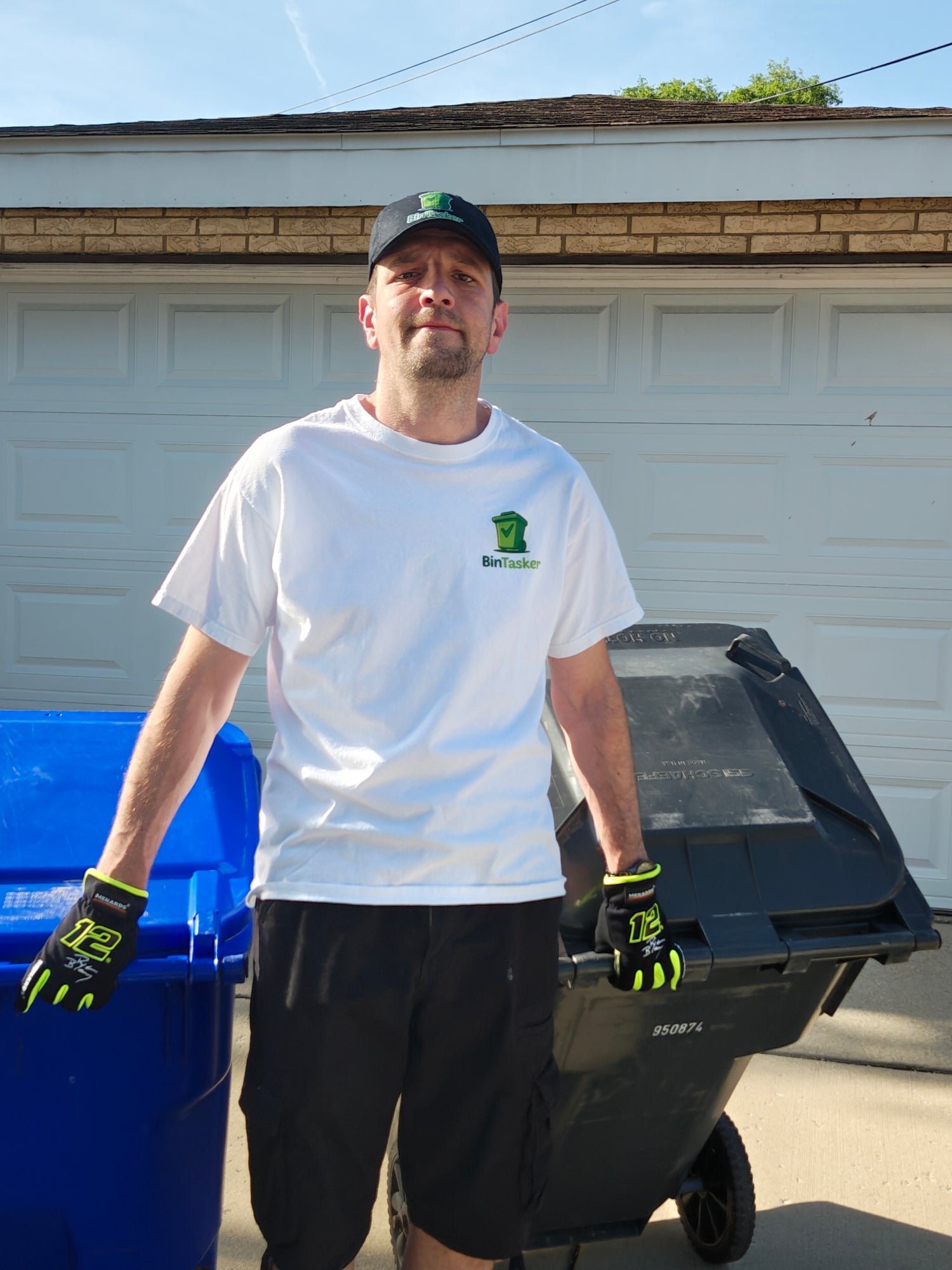 Petar, founder of BinTasker, with trash and recycling bins in a Chicago suburb driveway